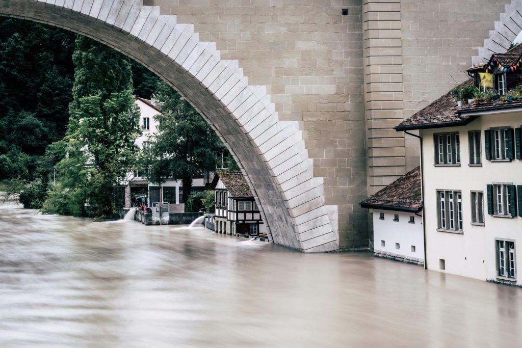 A powerful flood fills the riverbank near an iconic arch bridge in Bern, Switzerland.