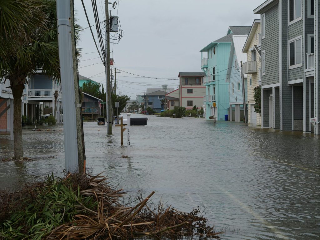 Street flooded with water and debris after storm.